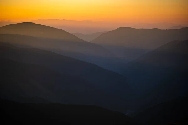 オレンジ色の空で日の出に山の暗いシルエット コピースペースの暗い背景 パラン山脈 ルーマニア ストック画像