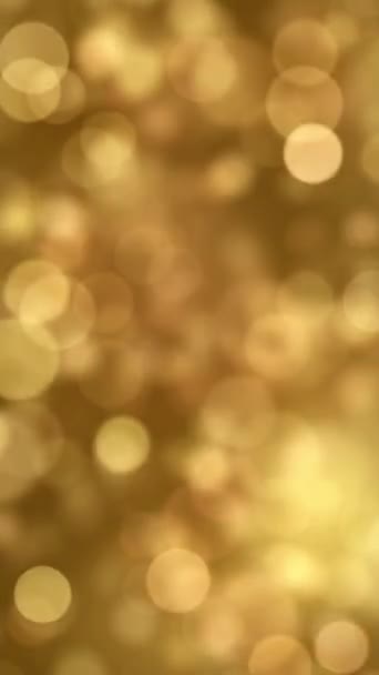 シームレスなループと垂直構成フォーマットでアニメーションされた金色光粒子のぼやけたボケの抽象的なクリスマスの背景 — ストック動画