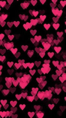  60 fps dikey kompozisyonda siyah arkaplan üzerinde pembe kalpler olan bir Sevgililer Günü arkaplanının animasyonu
