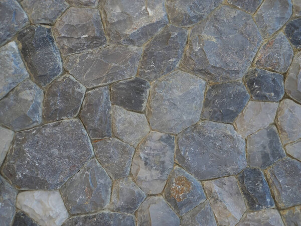 Background of gray stone wall texture, closeup, for design.