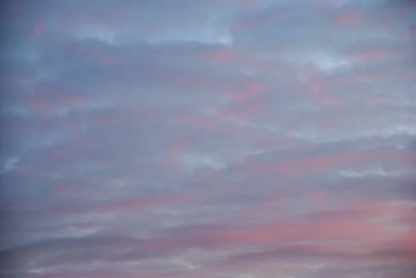 Pink purple clouds in the sky at dusk