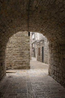 Ancient arched passageway in the old town of Budva, Montenegro