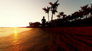 Gün batımında plajda koşan genç adamın silueti.