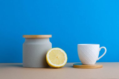 A front view of lemon decorated with tea in blue background