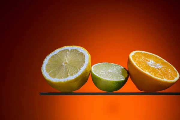 a piece and a sliced orange fruits with a orange background,abstract