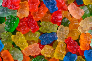 Farklı renkte jelibon ayıcıkları rastgele dağılmış. Eğlenceli, hayat dolu ve tatlı bir geçmişi var. Çocuk maması, tatlı menüleri, parti davetiyeleri ve eğlenceli yemek reklamları için mükemmel..