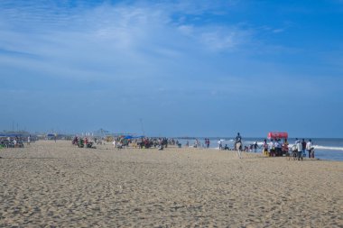 Chennai, Hindistan - 14 Temmuz 2023: Yerel halk Chennai, Tamil Nadu, Hindistan 'daki popüler Marina Sahili' nde eğleniyor. Bengal Körfezi kıyısında yer alan Hindistan 'ın en uzun plajıdır..