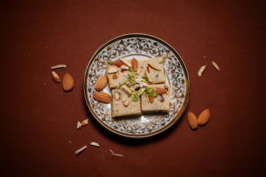 Bademlerle süslenmiş, seramik bir tabakta servis edilen 