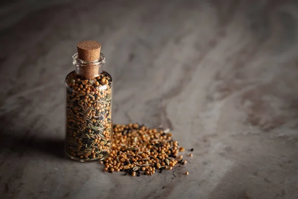 stock image A small glass bottle filled with a blend of five spices called 