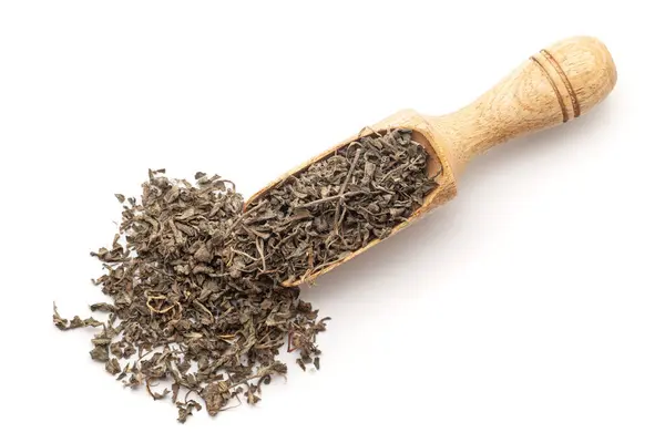 stock image Top view of a wooden scoop filled with Organic Bhringraj (Eclipta prostrata) leaves. Isolated on a white background.