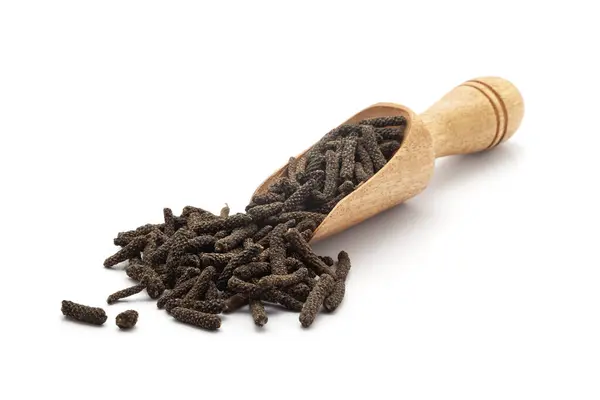 stock image Front view of a wooden scoop filled with Organic Long pepper (Piper longum) fruit. Isolated on a white background.