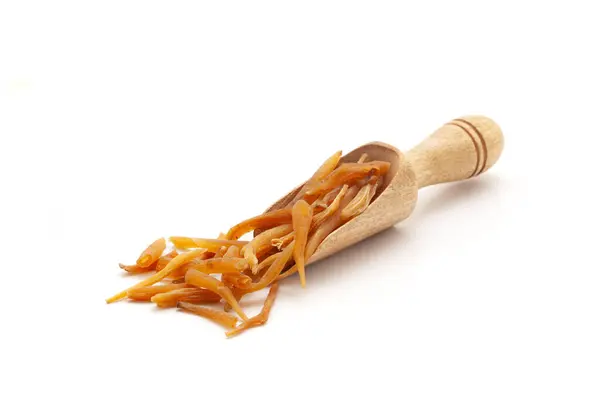 stock image Front view of a wooden scoop filled with dry Organic Shatavari (Asparagus racemosus) roots. Isolated on a white background.
