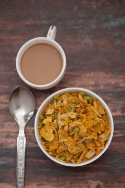 Close-Up of crunchy Indian mixture snacks with hot tea or Coffee time and handmade cookies (biscuits).  clipart