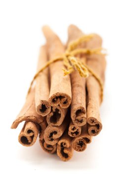 Close-up of Cinnamon sticks (Cinnamomum verum) isolated on a white background. Front view clipart