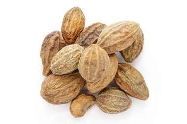 Organic dry Harad (Terminalia chebula) isolated on white background. Macro close up. Top view. clipart