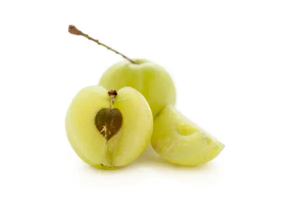 stock image One whole, half and slice of Organic Indian gooseberry or Amla (Phyllanthus emblica) with visible seed isolated on white background.