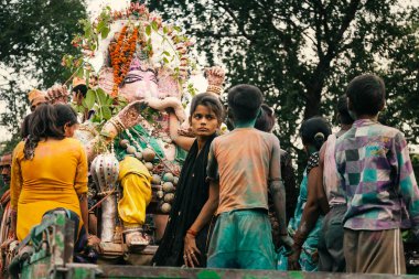 People carrying Hindu God Idol Ganesh for Holy Immersion (Ganpati Visharjan) at The Ganges River, INDIA clipart