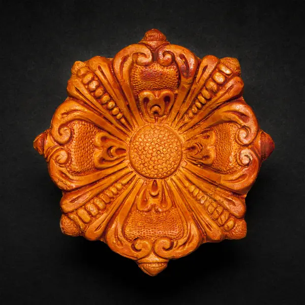 stock image Top view of a beautifully carved designer handmade clay lamp on dark background.