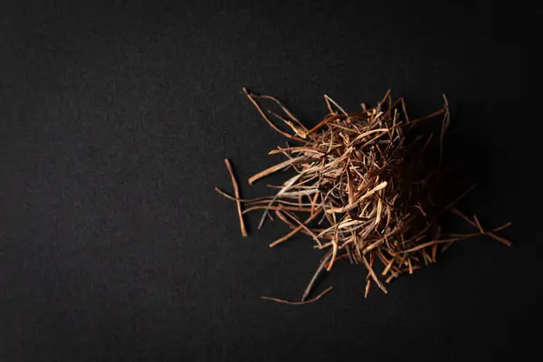 stock image A pile of Dry Organic Amar Bel (Cuscuta reflexa) roots, isolated on a black background. Top view