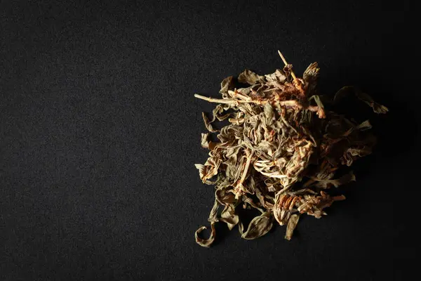 stock image A pile of Dry Organic Marijuana (Cannabis sativa) leaves, isolated on a black background. Top view