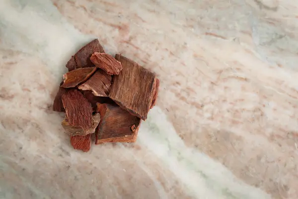 stock image A pile of Dry Organic Arjuna (Terminalia Arjuna) Barks, on a marble background. Top view