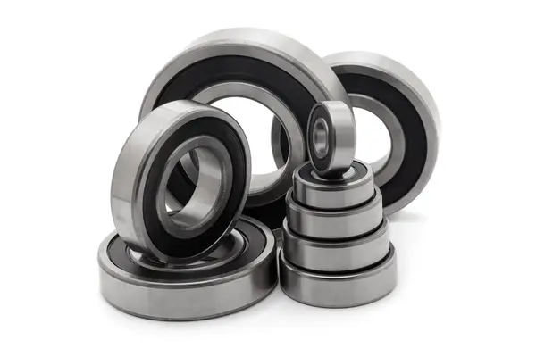 stock image A collection of assorted tapered roller bearings of various sizes, isolated on a white background.
