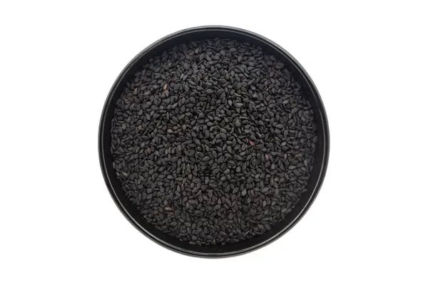 stock image Macro Close up of Organic Black Sesame seeds(Sesamum indicum) or Black Til with shell inside a black ceramic bowl