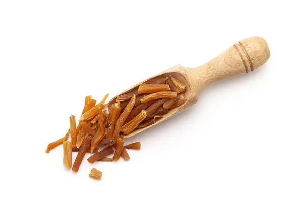 stock image Top view of a wooden scoop filled with Organic Shatavari (Asparagus racemosus) roots. Isolated on a white background.