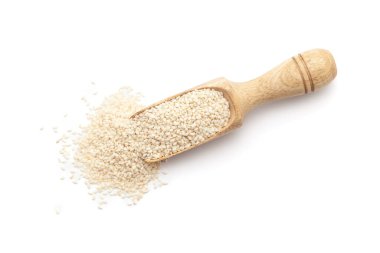 Top view of a wooden scoop filled with Organic White Sesame seeds (Sesamum indicum) or Til. Isolated on a white background. clipart