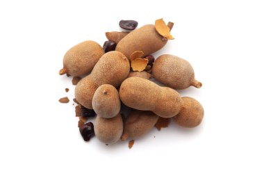 Top view of a pile of Fresh Organic Sweet Tamarind (Tamarindus indica) Fruit, isolated on a white background. clipart