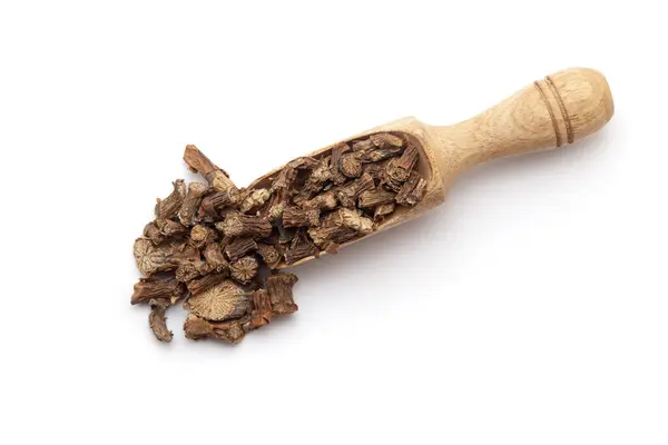 stock image Top view of a wooden scoop filled with dry Organic Gulvel or Giloy (Tinospora cordifolia) herb (Heart-leaved moonseed, guduchi, giloy, crispa). Isolated on a white background.