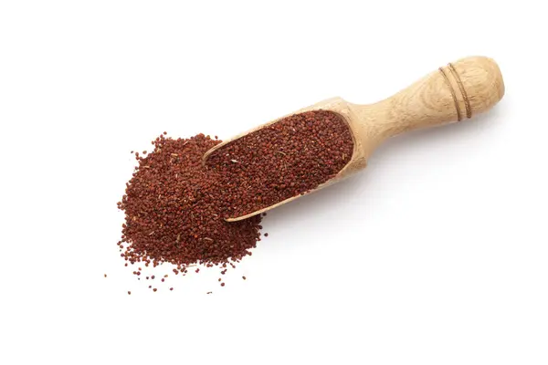 stock image Top view of a wooden scoop filled with dry Organic Sleeping plant or Lajvanti (Mimosa pudica) seeds. Isolated on a white background.