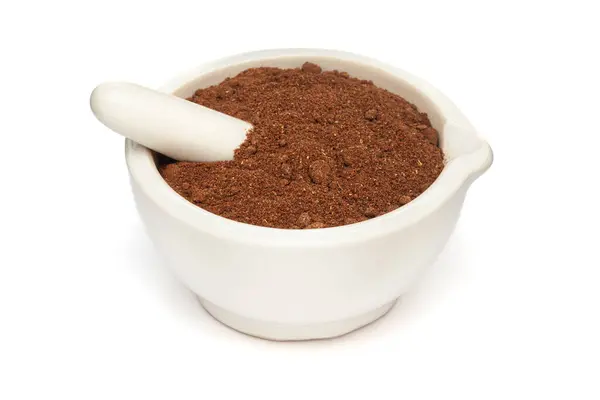 stock image Close-up of Organic Soapnut or Reetha (Sapindus mukorossi) powder with its Fruits, in white ceramic mortar and pestle, isolated on a white background.