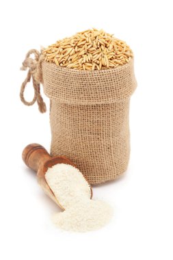 Close-up of Organic Rice with Bran (Oryza sativa) or Dhaan, in a jute bag and Rice Flour on a scoop, Isolated on a white background. clipart