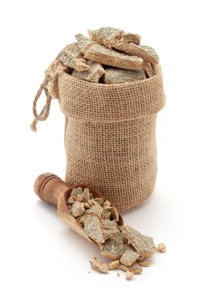 Stock image Close-up of Dry Organic Varuna Barks (Crataeva nurvala), in a jute bag and on a scoop, Isolated on a white background.