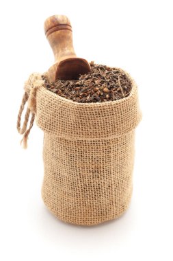 Close-up of dry Organic Green Holy Basil or  Rama Tulsi (Ocimum Sanctum) leaves, in a jute bag with a scoop, Isolated on a white background. clipart