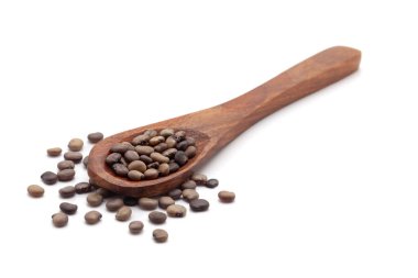 Front view of a wooden spoon filled with dry Organic cluster bean  (Cyamopsis tetragonoloba) seeds. Isolated on a white background. clipart