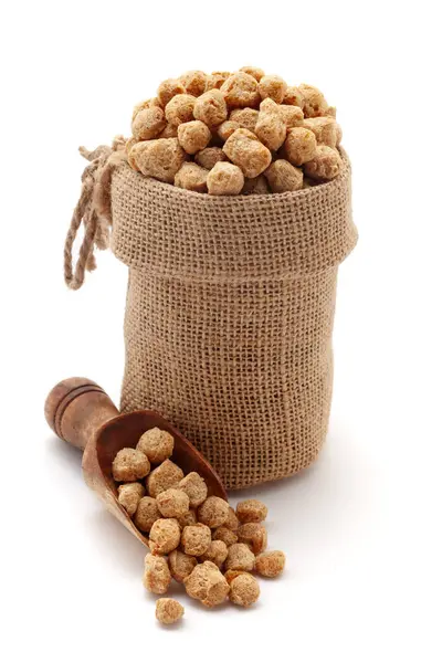 stock image Close-up of Organic Soya Chunks (Glycine max), in a jute bag and on a scoop, Isolated on a white background.