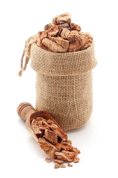 stock image Close-up of Dry Organic Semal Musli (Bombax Mulabaricum) herb, in a jute bag and on a scoop, Isolated on a white background.