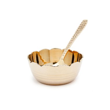 A brass bowl and spoon, placed on a white background, showcasing traditional Indian craftsmanship and elegance. clipart