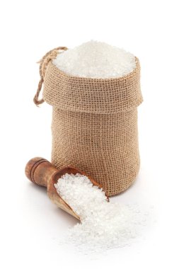 Close-up of refined white Sugar in a jute bag and on a scoop, isolated on a white background. clipart