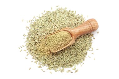 A wooden scoop filled with organic Fennel Seeds (Foeniculum vulgare) Badi saunf powder, placed over a heap of Fennel Seeds, isolated on a white background. clipart