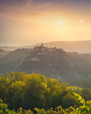 Langhe vineyards landscape and Castiglione Falletto village panorama at sunset, Unesco Site, Piedmont, Northern Italy Europe. clipart