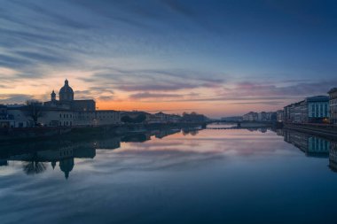 Cityscape of Florence after the sunset. Lungarno view, the arno river and the church of San Frediano in Cestello. Tuscany region, Italy clipart