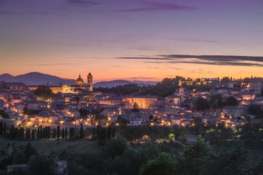 Urbino city skyline after sunset. Unesco world heritage site. Marche region, Italy, Europe.