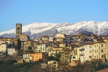 Coreglia Antelminelli, beautiful village and snowy Apennines mountains in the background in winter. Garfagnana, Tuscany region, Italy, Europe clipart