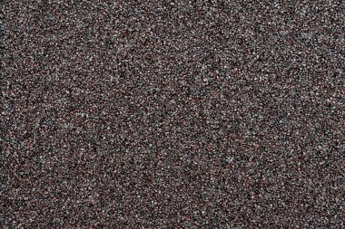 Küçük siyah taş dokusu ve deseni, yakın plan fotoğrafı arkaplan veya tasarım için uygun. Küçük siyah çakıl taşları ya da çakıl taşları ya da siyah asfalt büyümesine benzer..