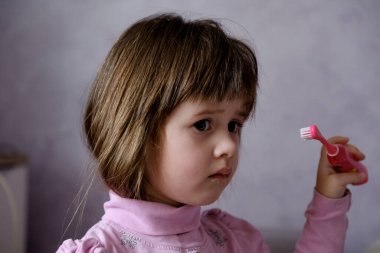 Little girl brushing her teeth. Oral hygiene.