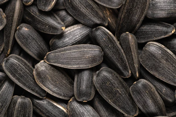 Macro image of organic black sunflower seeds, texture and background.