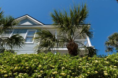 Wild Dunes - Isle of Palms, South Carolina, USA - April 11, 2023: Mansion at Wild Dunes Resort surrounded by tropical trees. clipart